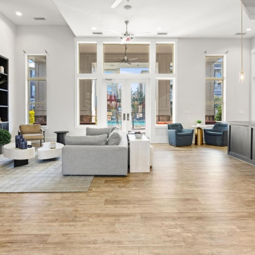 Large lounge room on wooden floors lounge areas with wooden accents and easy connection to other amenities